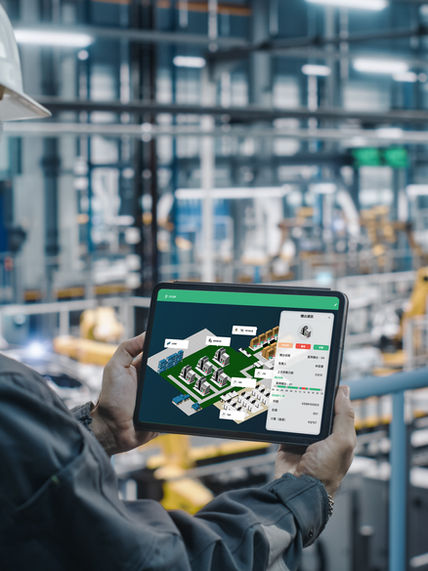 Engineer holding a tablet with FCOP factory map in a smart factory